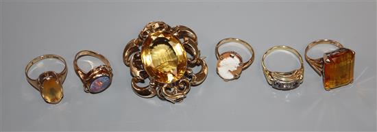 Three 9ct and gem set rings, one 585 gem set ring, one other yellow metal ring and a yellow metal and gem set brooch.